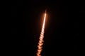 Minimalistic space shuttle launch capturing nighttime ascent with fiery trail Royalty Free Stock Photo