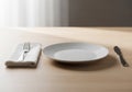 A minimalistic table setting features a light wood surface. A white, Royalty Free Stock Photo