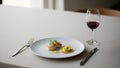 Piece of ravioli. A fork and knife rest beside the plate. Accompanying the Royalty Free Stock Photo