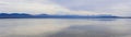 Minimalistic tranquil panorama of water and mountains, Tasmania