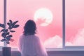 Minimalistic tranquility: woman enjoying serene sunset by a window Royalty Free Stock Photo
