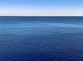 Minimalistic water surface with blue seascape horizon and clear gradient sky Royalty Free Stock Photo