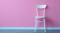 Minimalistic white chair against a pink wall