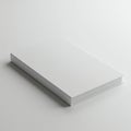 A minimalistic white hardcover book is positioned on a plain, light-colored surface. Royalty Free Stock Photo