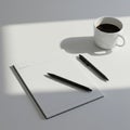A minimalistic workspace featuring a lined notepad, two black pens, and a white cup Royalty Free Stock Photo