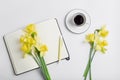 minimalistic workspace. white work desk with coffee mug, notepad, pen and flower. Royalty Free Stock Photo