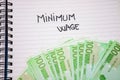 Minimum wage handwriting  text on paper, on office agenda. Copy space Royalty Free Stock Photo