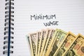 Minimum wage handwriting  text on paper, on office agenda. Copy space Royalty Free Stock Photo