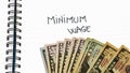 Minimum wage handwriting  text on paper, on office agenda. Copy space Royalty Free Stock Photo