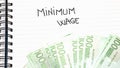 Minimum wage handwriting  text on paper, on office agenda. Copy space Royalty Free Stock Photo