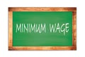 MINIMUM  WAGE text written on green school board Royalty Free Stock Photo