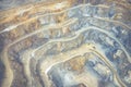 Mining from above. Industrial terraces on open pit mineral mine. Aerial view of opencast mining. Dolomite Mine Excavation.