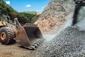 Mining and construction industry - Heavy duty wheel loader bulldozer loading granite rock Royalty Free Stock Photo