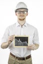 Mining engineer holding tablet with falling graph, looks at camera with smile Royalty Free Stock Photo