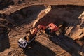 Mining excavator load the sand into dump truck in open pit. Developing the sand in the opencast. Heavy machinery on earthworks in Royalty Free Stock Photo