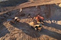 Mining excavator load the sand into dump truck in open pit. Developing the sand in the opencast. Heavy machinery on earthworks in Royalty Free Stock Photo