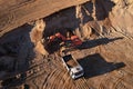 Mining excavator load the sand into dump truck in open pit. Developing the sand in the opencast. Heavy machinery on earthworks in Royalty Free Stock Photo