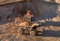 Mining excavator load the sand into dump truck in open pit. Developing the sand in the opencast. Heavy machinery on earthworks in Royalty Free Stock Photo