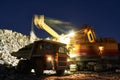 Mining. excavator loading granite or ore into dump truck