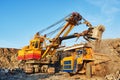 Mining. excavator loading granite or ore into dump truck Royalty Free Stock Photo