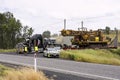 Mining machinery being escorted onto highway.