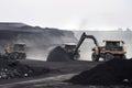 mining operation, with workers and machinery transporting coal from the mine