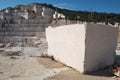 Marble block on foreground and quarry at background