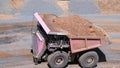 Mining truck in the process of transporting minerals from the bottom of the mine pit Royalty Free Stock Photo
