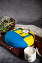 Minion Cake with rose flowers, knife and fork served on board isolated on napkin side view of cafe baked food