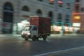 Minivan Piaggio Porter utility driving on the street at night