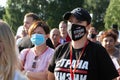 Portrait of young woman in protective mask in the park