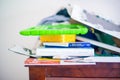 MINNEAPOLIS, MINNESOTA / USA - JULY 7, 2019: Cluttered pile on top of dresser with ipad, books, clothes, and more