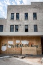 Damaged building and haunting graffiti message after looting and minneapolis riots for George Floyd in Black Lives Matter protests Royalty Free Stock Photo