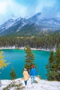 Minnewanka lake in Canadian Rockies in Banff Alberta Canada with turquoise water is surrounded by coniferous forests Royalty Free Stock Photo