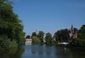 Minnewater gothic castle at the Lake of Love in Bruges, Belgium, bright sunny day, beautiful landscape Royalty Free Stock Photo