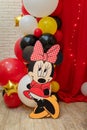 Minnie Mouse party. Character of Walt Disney cartoon with colorful balloons