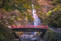 Minoo Waterfall in Colorful Autumn Season with Red Maple Leaf Fall Foliage and Beautiful Red Bridge. Royalty Free Stock Photo