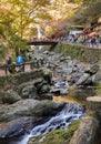 Minoo waterfall with red bridge in autumn at Minoo or Minoh national park in Osaka, Japan Royalty Free Stock Photo