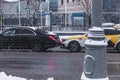 Minor car accident involving two cars on winter city street. Consequences of not keeping the distance on wet and slippery road Royalty Free Stock Photo