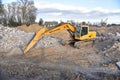 Excavator HYUNDAI work at landfill with concrete demolition waste. Salvaging and recycling building and