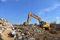Excavator HYUNDAI work at landfill with concrete demolition waste. Salvaging and recycling building and