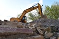 Excavator HYUNDAI work at landfill with concrete demolition waste. Salvaging and recycling building and