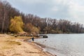 Minsk, Belarus, April, 18, 2020. Little boy runs along the lake on a sunny day