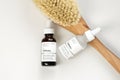 The Ordinary skincare brand by Deciem. Bottles with oil and treatments. Massage anti cellulite body brush. Spa concept