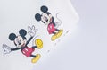 Minsk Belarus, April 9, 2020: Woman fashion clothes flat lay on white background top view. Flat lay hoody with 3 Mickey Mouse