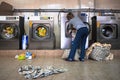 Woman wash clothes in the public laundry room