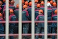 Crowd of works in orange helmets. Strike of factory workers. Unemployment concept Royalty Free Stock Photo