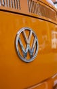 Minsk, Belarus, August 14 2018 - Orange Volkswagen Type 2 VW T2 parked on the street VW Logo close-up shot, known as the Royalty Free Stock Photo