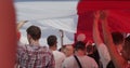 MINSK, BELARUS - AUGUST 16, 2020: People Carry Giant White-red-white Historical Flag Down The Street. Belarusians Took