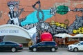 Street art on Oktyabrskaya street. Graffiti cat, giraffes, roses, kiss on wall of industrial building, Minsk, Belarus Royalty Free Stock Photo